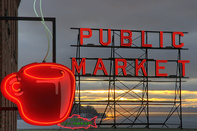 red neon public market sign with a coffee cup