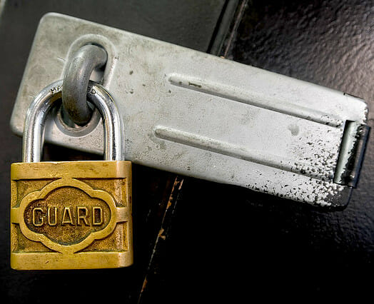 guard padlock locking a latch