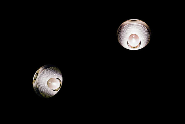 2 light bulbs lighting up the dark