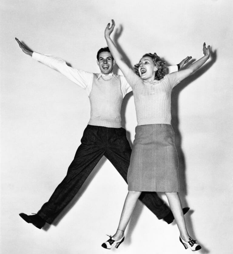 retro couple jumping for joy