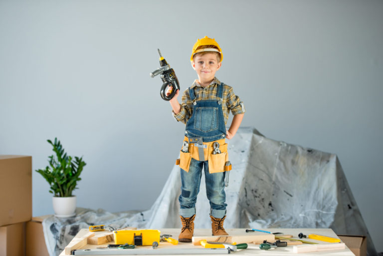 little boy wearing construction outfit