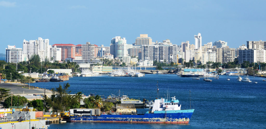 photo of port with ships and buildings in background