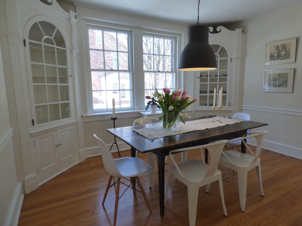 white dining room with tulips on the table