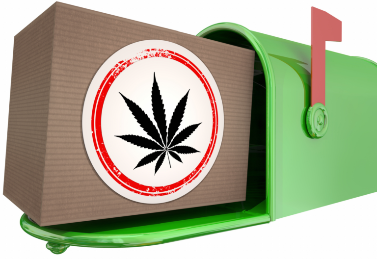 Box with large cannabis sticker on it in green mailbox