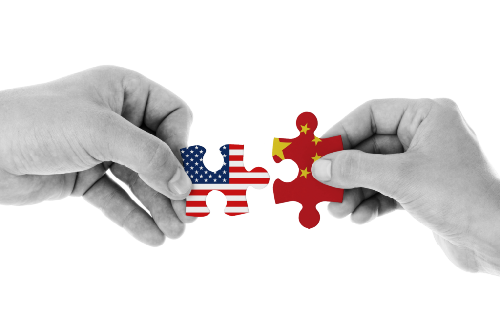 two people holding puzzle piece with chinese and american flag